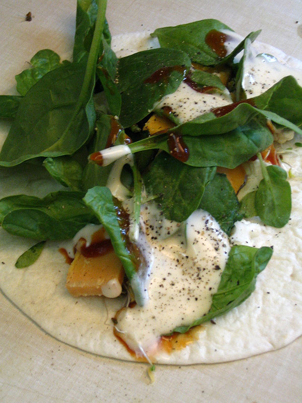 Food - Greens and cheese in a wrap with a yogurt pepper sauce!